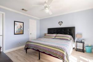 a bedroom with a bed and a ceiling fan at Oceanfront at The Dawns in Galveston