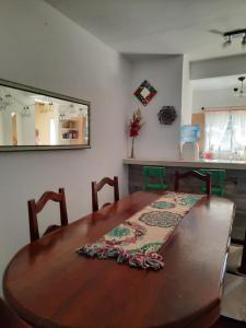 a dining room table with a rug on top of it at Loma Blanca in Libertador General San Martín