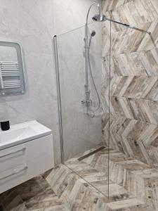a bathroom with a shower and a white sink at Sonio Boutique Hotel in Mamaia +57 photos