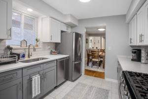 a kitchen with a stainless steel refrigerator and a dining room at Chicago Charm in Chicago