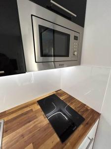 a kitchen with a microwave and a wooden counter top at Magnifique studio au bord de mer in Nice