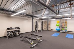 a gym with several treadmills and dumbbells at Flexhome Brewery District 2BR Apt M2 - READ INFO in Milwaukee