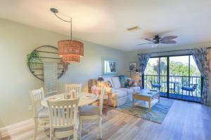 a living room with a table and a couch at Lake Palms 3 in Sanibel