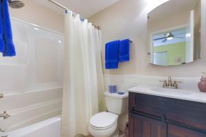 a bathroom with a toilet and a sink and a mirror at Lake Palms 3 in Sanibel
