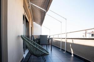 - un balcon avec une table et des chaises dans un bâtiment dans l'établissement Syggrou Project 44, à Thessalonique