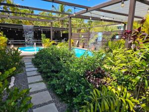 un jardin avec une piscine et une fontaine dans l'établissement Discovery Beach Apartments, à Aguada