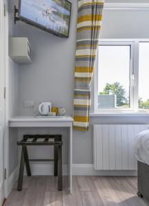 a bedroom with a table and a window at Newtown Cove Room 1 in Waterford