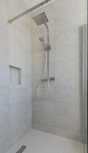 a shower with a shower head in a bathroom at Newtown Cove Room 1 in Waterford