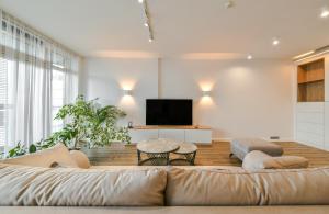a living room with a large couch and a tv at K129 Living Apartment in Vilnius Center in Vilnius