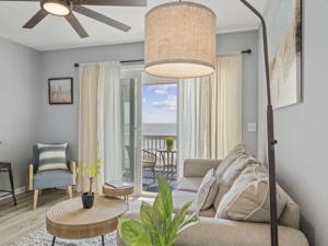 a living room with a couch and a table at A Little Shore Thing condo in Carolina Beach