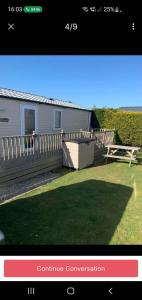 a picture of a house with a fence at Ocean Heights 5 star site NewQuay in Llanllwchaiarn