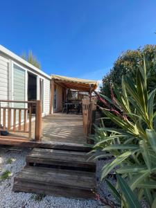 a house with a wooden porch with a deck at RELAX FO70 in Fréjus