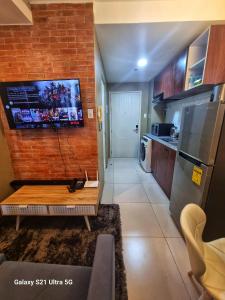 a kitchen with a table and a refrigerator in a room at Luxurious Romantic Getaway in a stylish Condo in Tagaytay