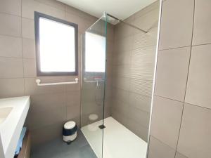 a bathroom with a glass shower and a sink at Gîtes Domaine de la chapelle in Roquefort-les-Pins