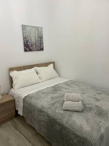 a bedroom with a bed with a pillow on it at Enastron Cozy & Quiet Apartment in Heraklio