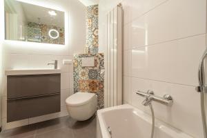 een witte badkamer met een toilet en een wastafel bij CASASdeCASPER - Apartment Alkmaar in Alkmaar +12 foto's