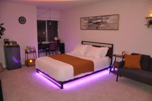 a bedroom with a bed with a purple light at Exclusive Private Room in the Shared Apartment by the Ocean in Los Angeles