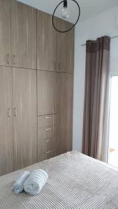 a bedroom with a bed with two towels on it at Iliaktis Cozy & Quiet Apartment in Heraklio Town