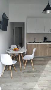 a kitchen with a table and two white chairs at Iliaktis Cozy & Quiet Apartment in Heraklio Town