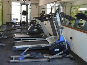 a gym with several tread machines in a row at Furnished Apt near Palolem Beach¶WiFi ¶Forest view in Canacona