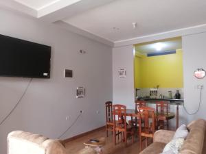 a living room with a couch and a table at MI SELVA Y SU ENCANTO in La Merced