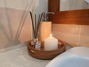 a candle sitting on a bathroom counter next to a sink at Dharma Shanti Villa - Private Pool - Peaceful Ubud Escape in Ubud +13 photos