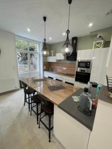 a kitchen with a large island with a counter top at Au Beau Duplex de la Basilique in Boulogne-sur-Mer