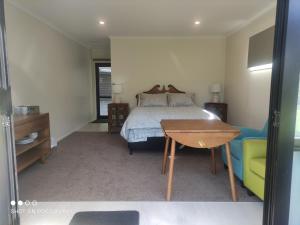 a bedroom with a bed and a table and a desk at Cambridge Coach House in Cambridge