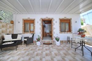 a living room with a couch and a table at Vasia's Small Villa in Skopelos Town