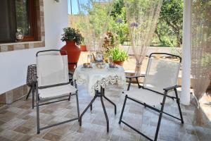 a patio with a table and two chairs at Vasia's Small Villa in Skopelos Town +40 photos