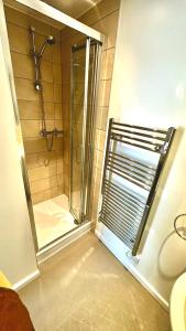 a shower with a glass door in a bathroom at Andorra Guest Accommodation in Brighton & Hove