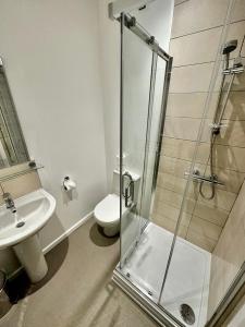 a bathroom with a shower and a toilet and a sink at Andorra Guest Accommodation in Brighton & Hove