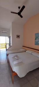 Katil atau katil-katil dalam bilik di Pousada Solar das Flores