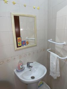 a bathroom with a sink and a mirror and a toilet at Almograve - Praias in Almograve