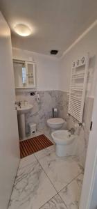 biała łazienka z toaletą i umywalką w obiekcie Residence Jolly w Mediolanie