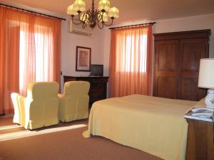 Postel nebo postele na pokoji v ubytování Hotel Umbra