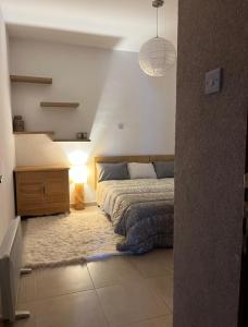 a bedroom with a bed and a lamp in it at Mermaid Holiday Apartments in Mandria