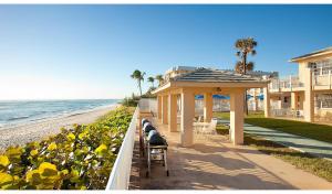 a gazebo on a sidewalk next to the beach at Gulfstream Manor in Delray Beach