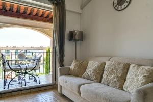 a living room with a couch and a balcony at Studio With Balcony Overlooking The Port in Grimaud