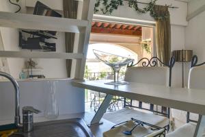 a dining room with a table and a wine glass at Studio With Balcony Overlooking The Port in Grimaud