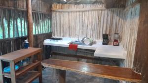 a small kitchen with a sink and a counter at Aldea Yuyu in Tulum