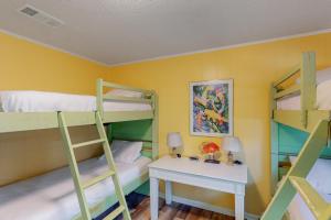 a bunk bed room with a desk and bunk beds at Mondo Kayo in Gulf Shores +100 photos