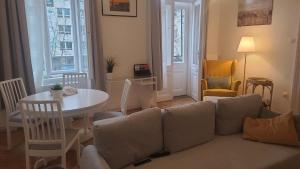 a living room with a couch and a table at Terrace VuVu - Apartment with balcony in the heart of Budapest in Budapest