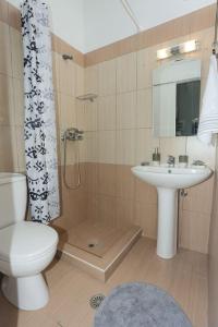 a bathroom with a toilet and a sink and a shower at Fox Studio, Corfu in Alepou