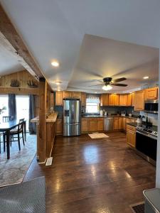 a large kitchen with wooden cabinets and a table at Osceola #13 Mine House 