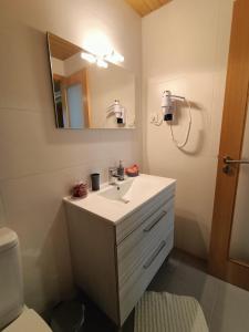 a bathroom with a white sink and a mirror at Casa da Aldeia 2021 in Escalhão +14 photos