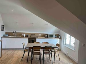 a kitchen and dining room with a table and chairs at Les Familles à la mer in Merlimont