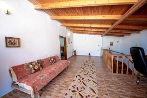 a living room with a couch and a wooden ceiling at Nina's Guesthouse in Gjirokastër