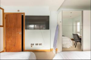 a bedroom with two beds and a sliding glass door at Razak House in Brighton & Hove