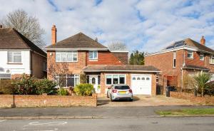 a car parked in front of a brick house at Razak House in Brighton & Hove